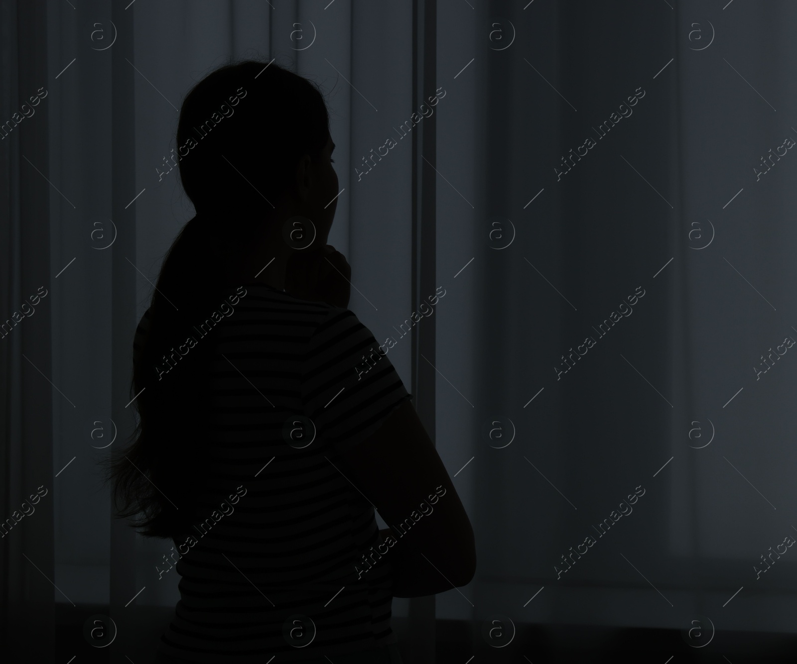 Silhouette of sad young woman at home. space for text Photo of Silhouette of sad young woman at home. space for text