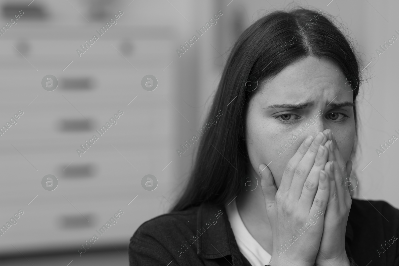 Sad young woman at home, space for text. Black and white effect Photo of Sad young woman at home, space for text. Black and white effect