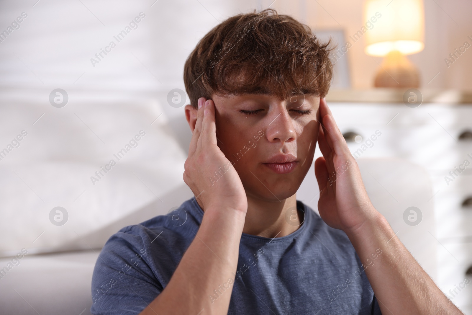 Photo of Teenage boy meditating at home. Way to stop panic attack