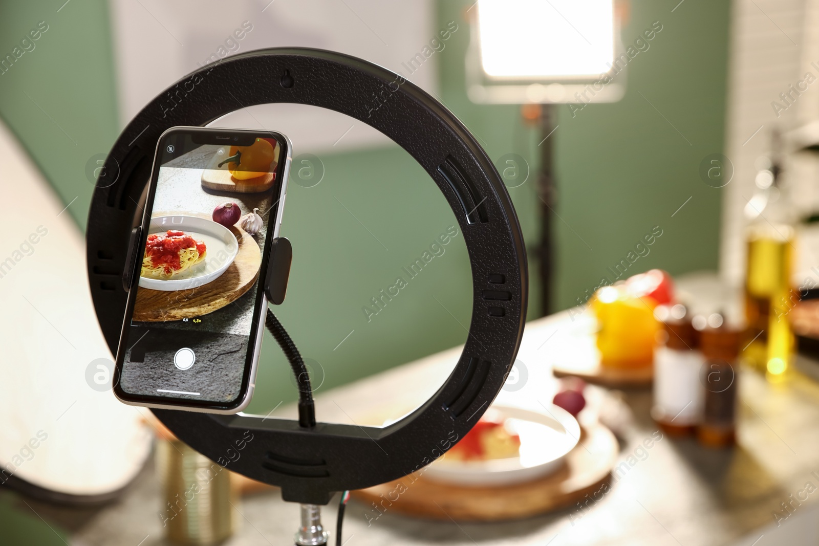 Shooting tasty pasta and ingredients with smartphone in studio, selective focus. Professional food photography Photo of Shooting tasty pasta and ingredients with smartphone in studio, selective focus. Professional food photography