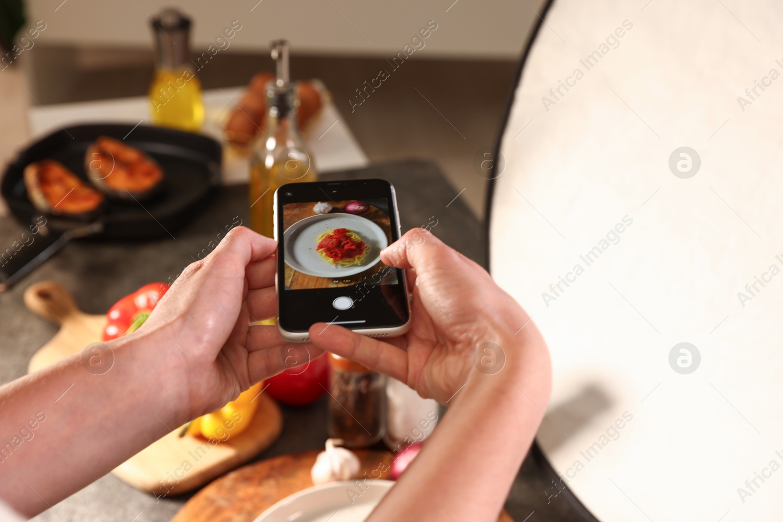 Woman taking picture of tasty pasta and ingredients in studio, selective focus. Professional food photography Photo of Woman taking picture of tasty pasta and ingredients in studio, selective focus. Professional food photography