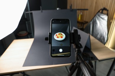 Photo of Shooting tasty pasta with smartphone in studio, focus on screen. Professional food photography