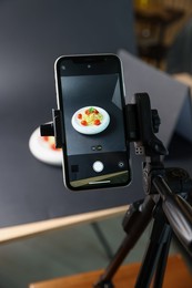 Photo of Shooting tasty pasta with smartphone in studio, focus on screen. Professional food photography