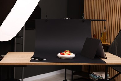 Photo of Shooting tasty pasta with smartphone in studio, focus on screen. Professional food photography