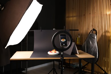 Photo of Shooting tasty pasta with smartphone in studio, focus on screen. Professional food photography