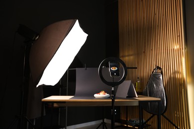 Photo of Shooting tasty pasta with smartphone in studio, focus on screen. Professional food photography