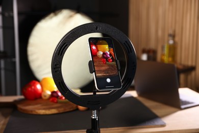 Photo of Shooting vegetables with smartphone in studio, focus on screen. Professional food photography