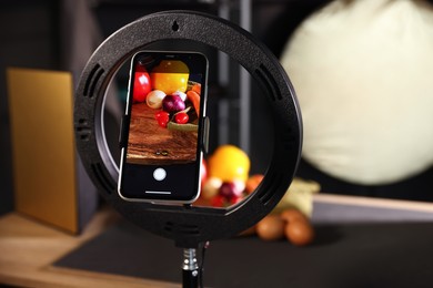 Photo of Shooting vegetables with smartphone in studio, focus on screen. Professional food photography