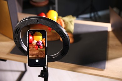 Photo of Shooting vegetables with smartphone in studio, focus on screen. Professional food photography