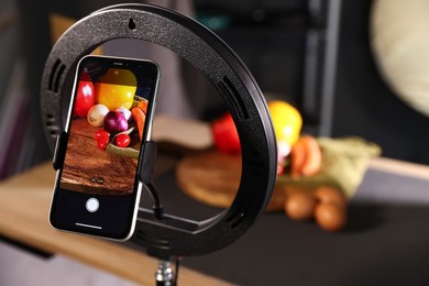 Photo of Shooting vegetables with smartphone in studio, focus on screen. Professional food photography