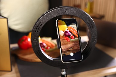 Photo of Shooting vegetables with smartphone in studio, focus on screen. Professional food photography