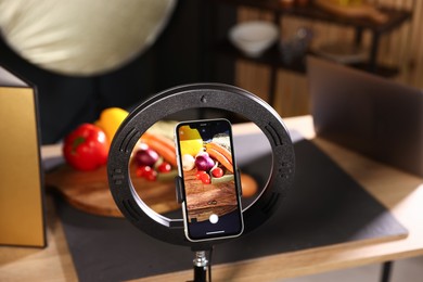 Photo of Shooting vegetables with smartphone in studio, focus on screen. Professional food photography