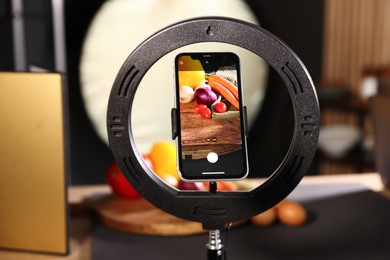 Photo of Shooting vegetables with smartphone in studio, focus on screen. Professional food photography
