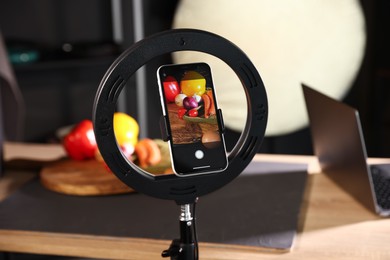 Photo of Shooting vegetables with smartphone in studio, focus on screen. Professional food photography