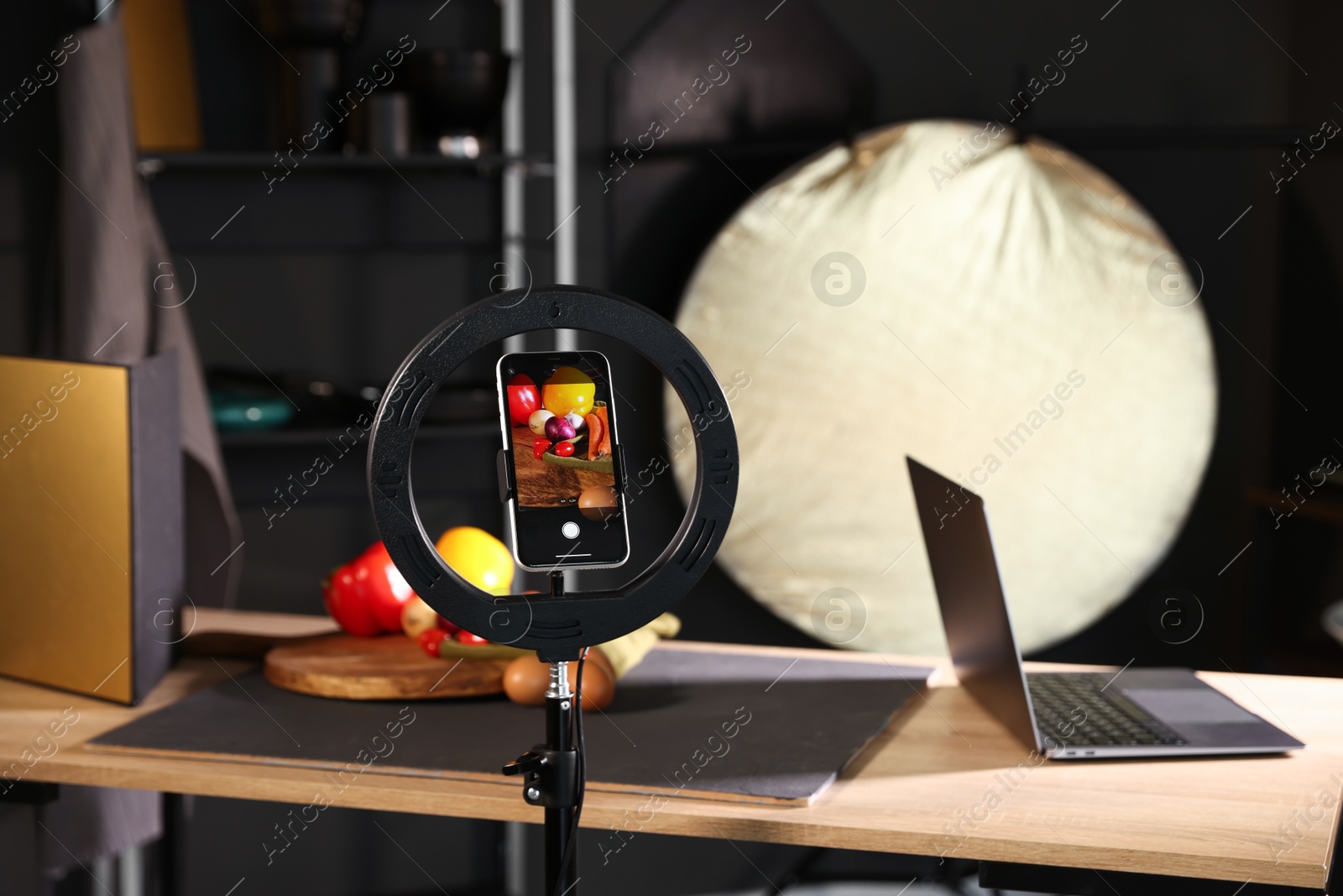 Photo of Shooting vegetables with smartphone in studio, focus on screen. Professional food photography