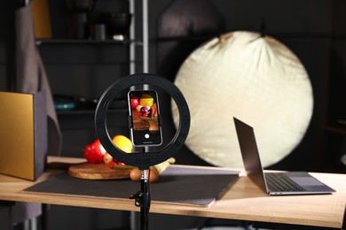 Photo of Shooting vegetables with smartphone in studio, focus on screen. Professional food photography