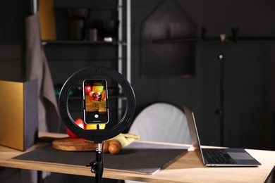 Photo of Shooting vegetables with smartphone in studio, focus on screen. Professional food photography