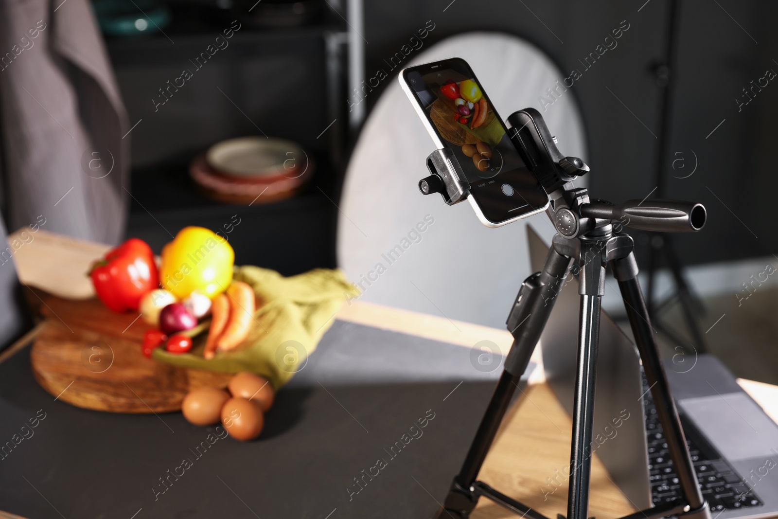 Photo of Shooting vegetables with smartphone in studio, selective focus. Professional food photography