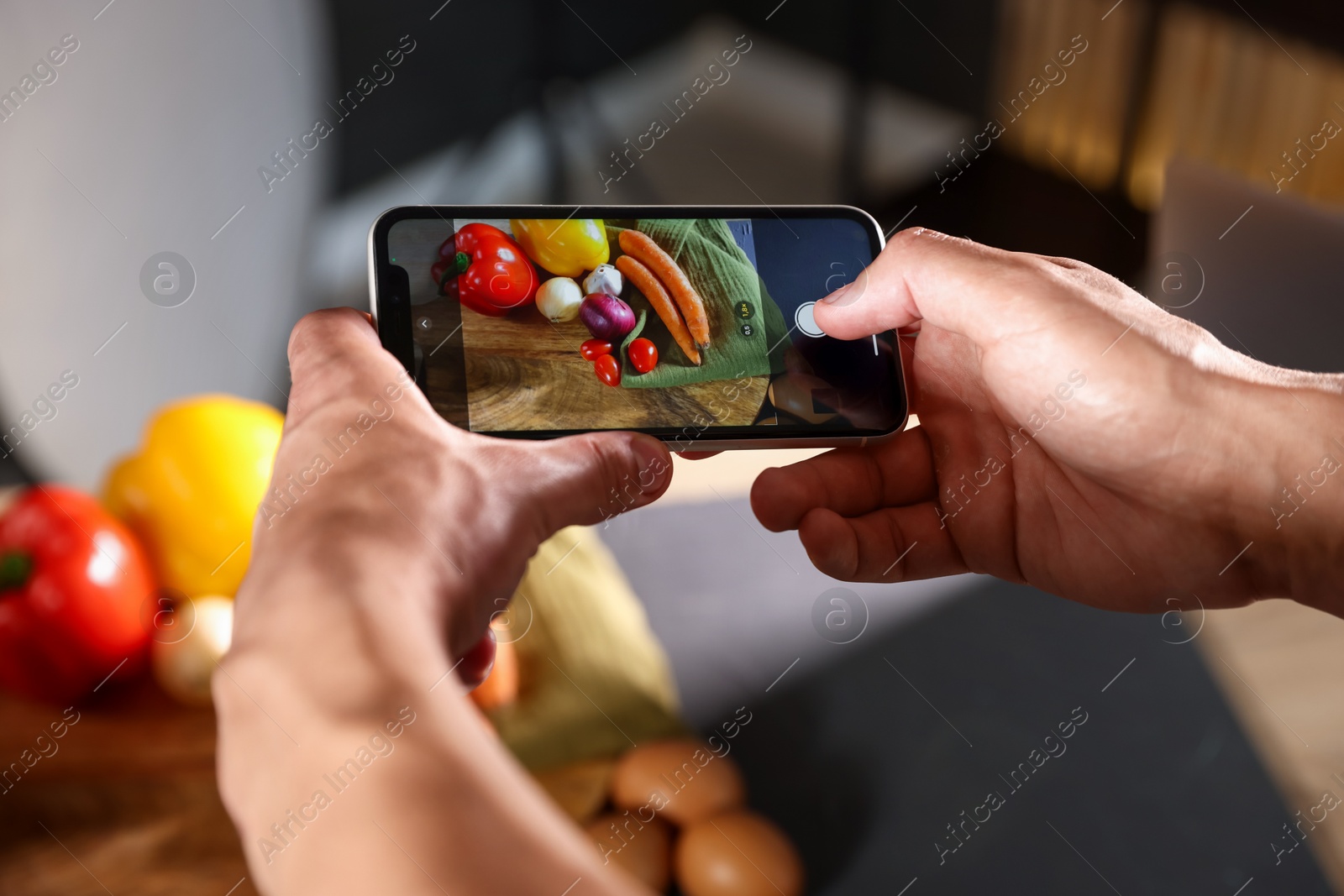 Photo of Woman taking picture of vegetables with smartphone in studio, closeup. Professional food photography