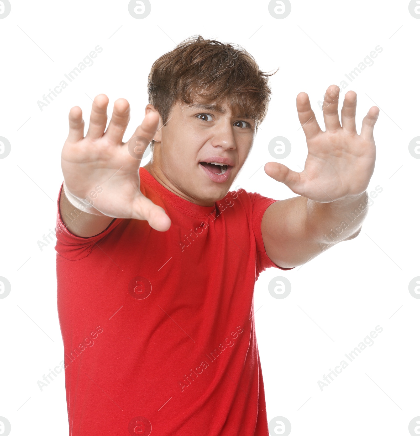 Teenage boy suffering from panic attack on white background Photo of Teenage boy suffering from panic attack on white background