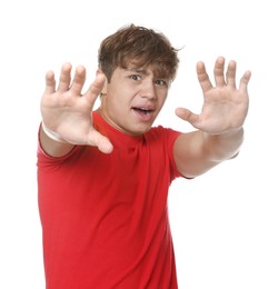 Photo of Teenage boy suffering from panic attack on white background