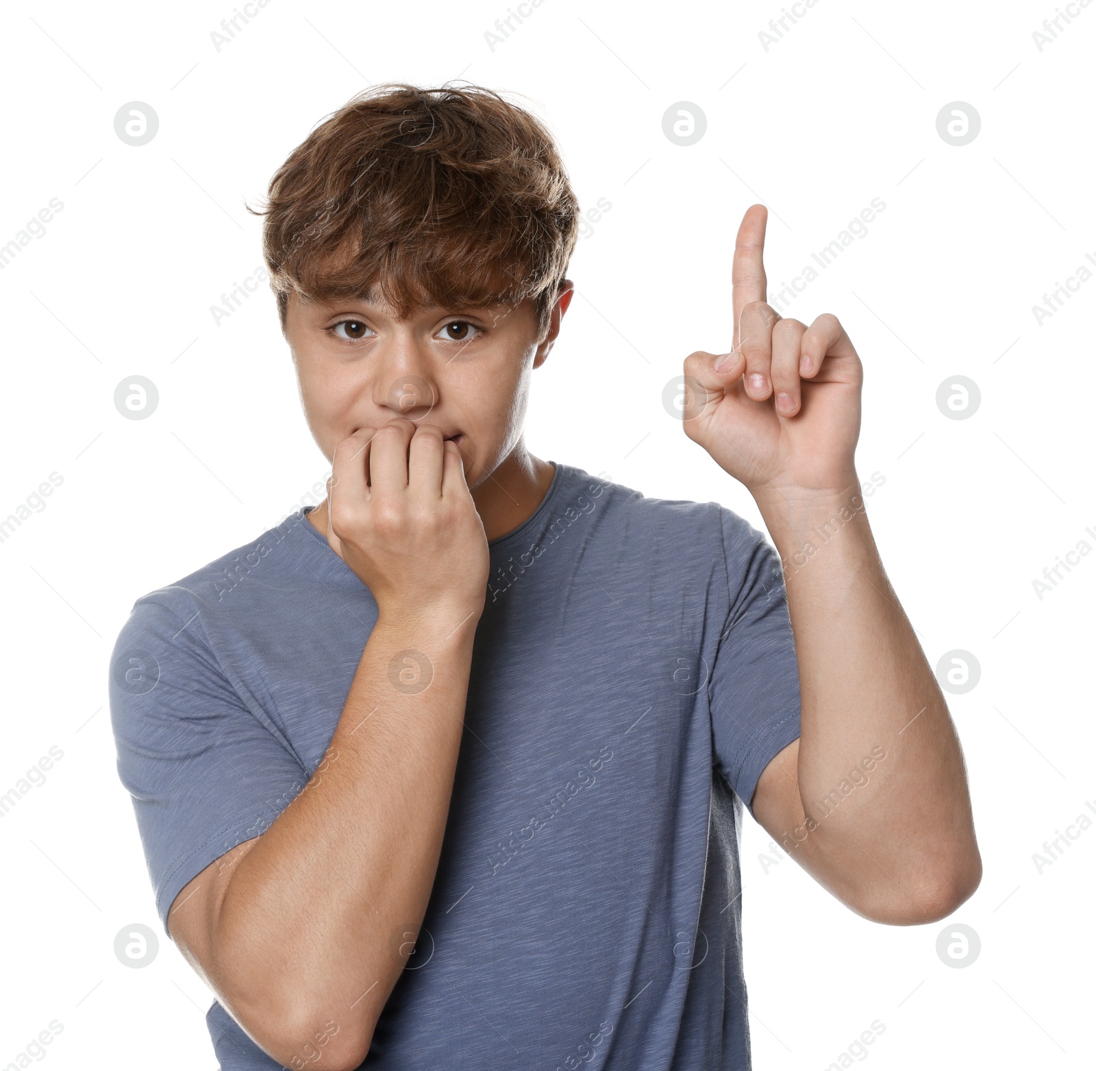 Photo of Teenage boy pointing upwards on white background