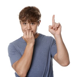 Photo of Teenage boy pointing upwards on white background
