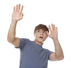 Photo of Teenage boy suffering from panic attack on white background
