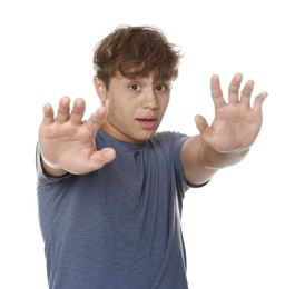 Photo of Teenage boy suffering from panic attack on white background