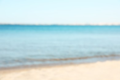 Photo of Beautiful sea and shore under light blue sky, blurred view