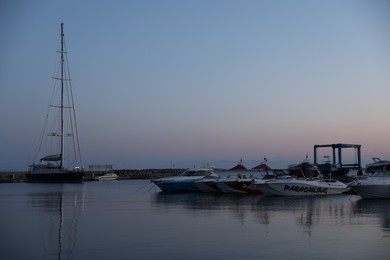 Photo of Sveti Vlas, Bulgaria - July 11, 2025: Moored ferries and boats in sea port at sunset