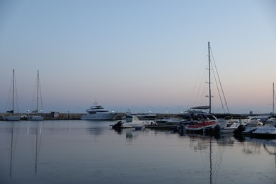 Photo of Sveti Vlas, Bulgaria - July 11, 2025: Moored ferries and boats in sea port at sunset