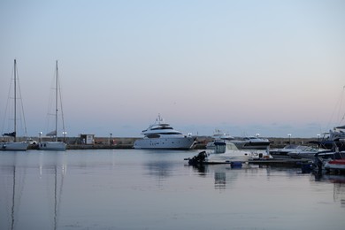Photo of Sveti Vlas, Bulgaria - July 11, 2025: Moored ferries and boats in sea port at sunset