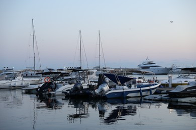 Photo of Sveti Vlas, Bulgaria - July 11, 2025: Moored ferries and boats in sea port at sunset