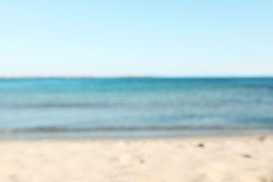 Photo of Beautiful sea and shore under light blue sky, blurred view