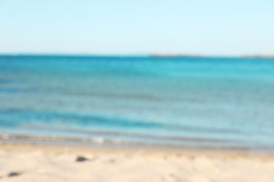 Photo of Beautiful sea and shore under light blue sky, blurred view