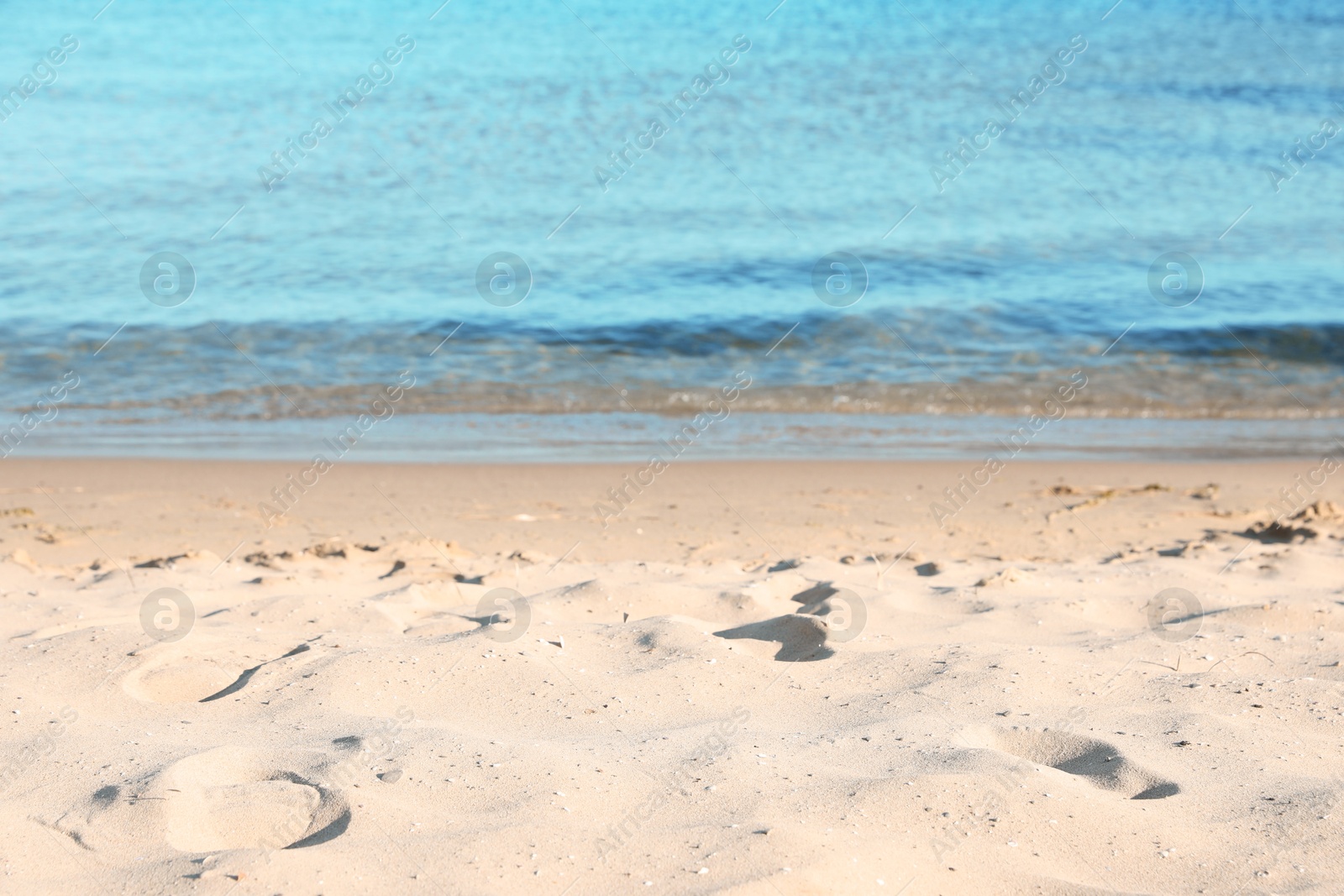 Photo of Beautiful wavy sea and sandy beach on sunny morning