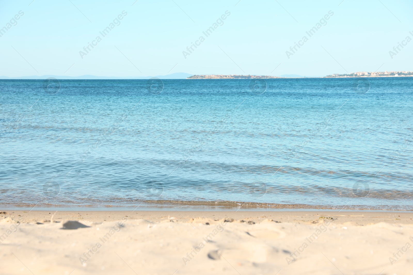 Photo of Beautiful sea and sandy beach under light blue sky