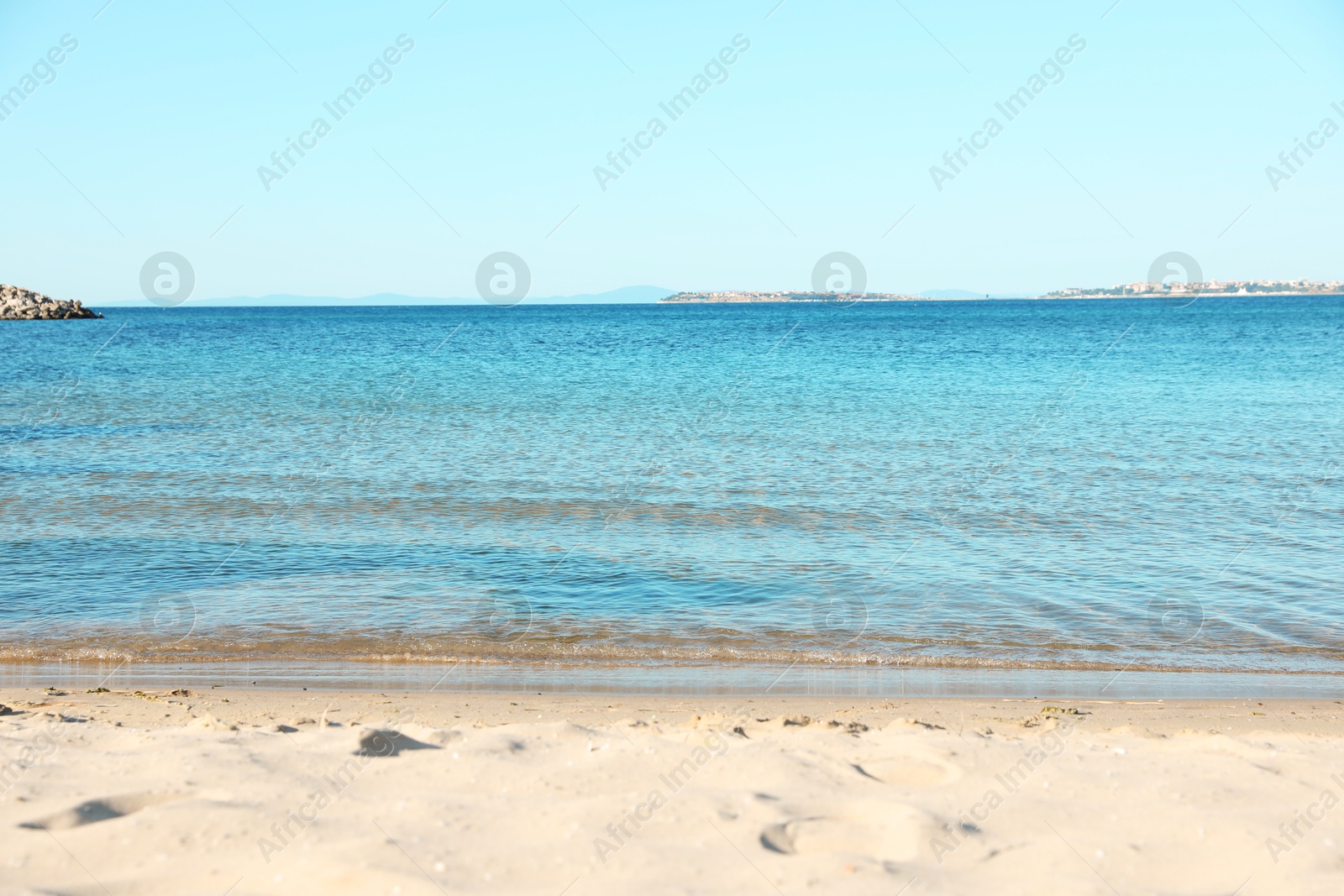 Photo of Beautiful sea and sandy beach under light blue sky