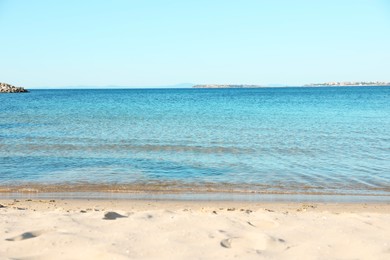 Photo of Beautiful sea and sandy beach under light blue sky