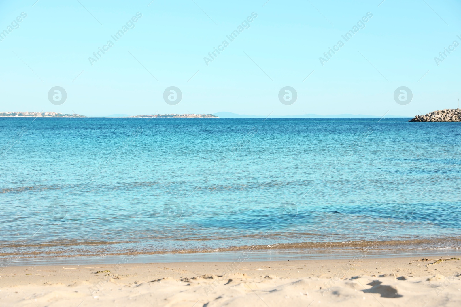 Photo of Beautiful sea and sandy beach under light blue sky