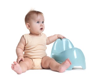 Photo of Cute little baby sitting near potty on white background
