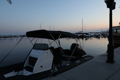 Photo of Sveti Vlas, Bulgaria - July 11, 2025: Moored boat near pier in sea at sunset