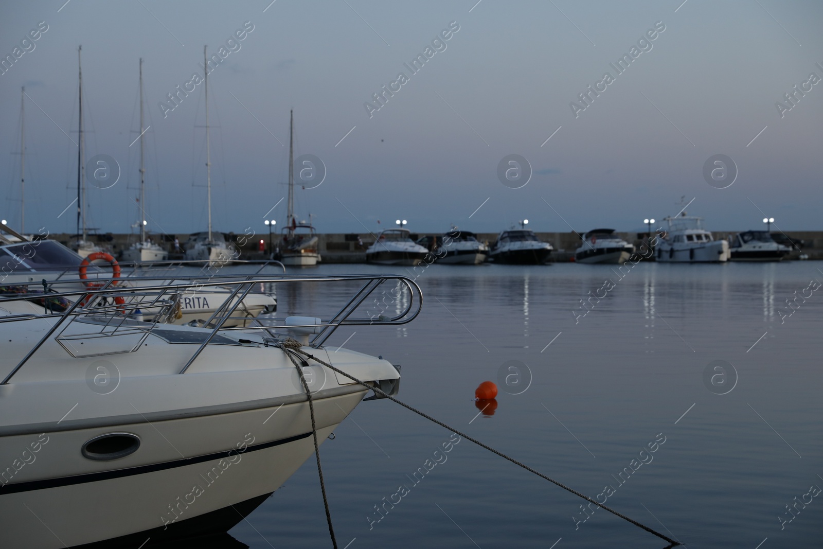 Photo of Sveti Vlas, Bulgaria - July 11, 2025: Moored ferries and boats in sea port at sunset