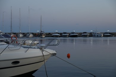 Photo of Sveti Vlas, Bulgaria - July 11, 2025: Moored ferries and boats in sea port at sunset