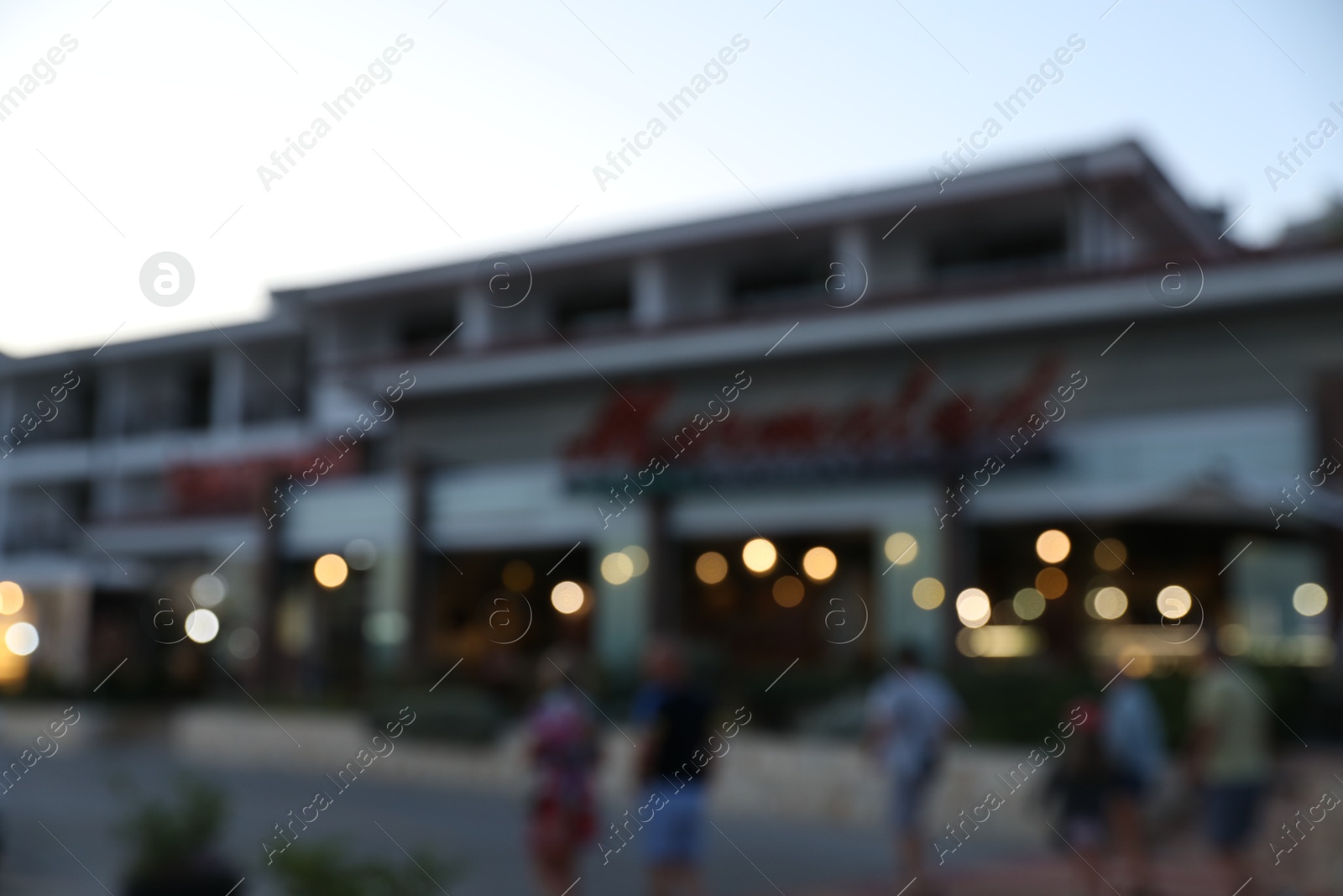 Hotel building in evening city, blurred view Photo of Hotel building in evening city, blurred view