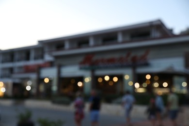 Photo of Hotel building in evening city, blurred view