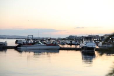 Photo of Moored boats in sea port at sunset, blurred view