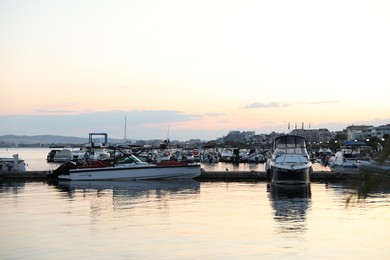 Photo of Sveti Vlas, Bulgaria - July 11, 2025: Moored boats near pier in sea at sunset