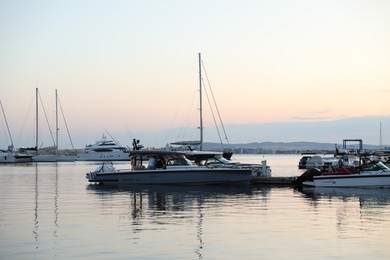 Photo of Sveti Vlas, Bulgaria - July 11, 2025: Moored ferries and boats in sea port at sunset